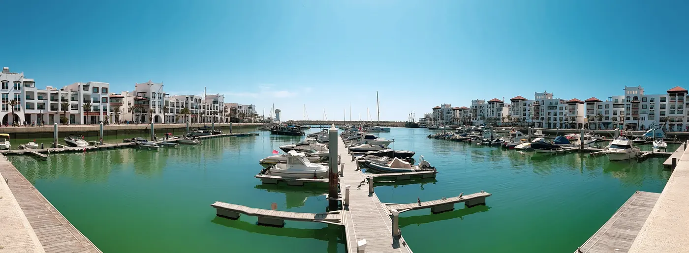 Panoramic daylight view of boats and buildings around Marina Agadir, Morocco, photographed in 2020.