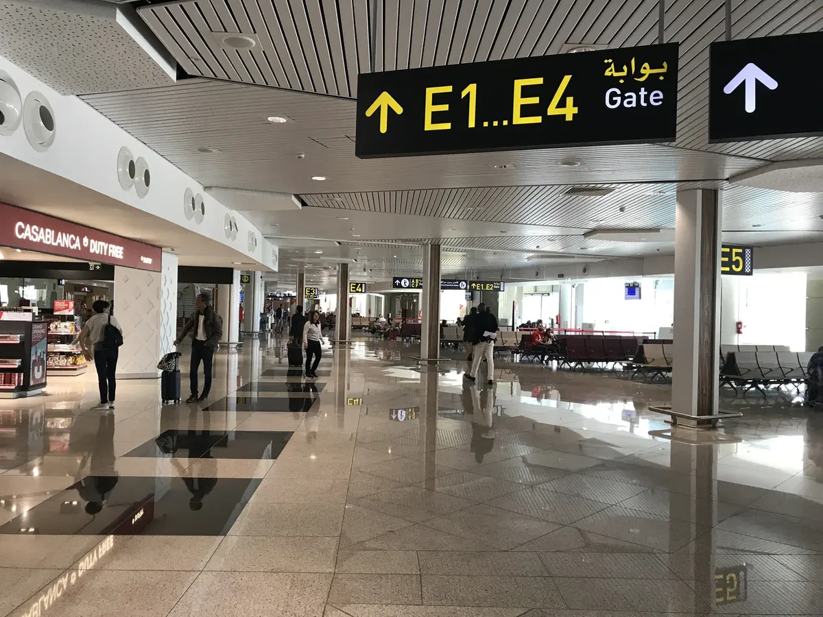 Interior of Terminal 1 at Casablanca Mohammed V International Airport, with passenger seating and departures signage