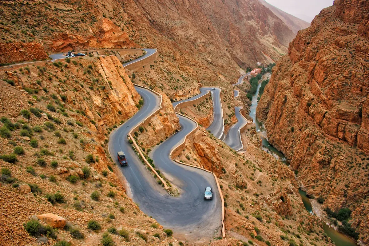 A paved road curves in tight switchbacks between rocky walls in Morocco’s Dades Gorge.