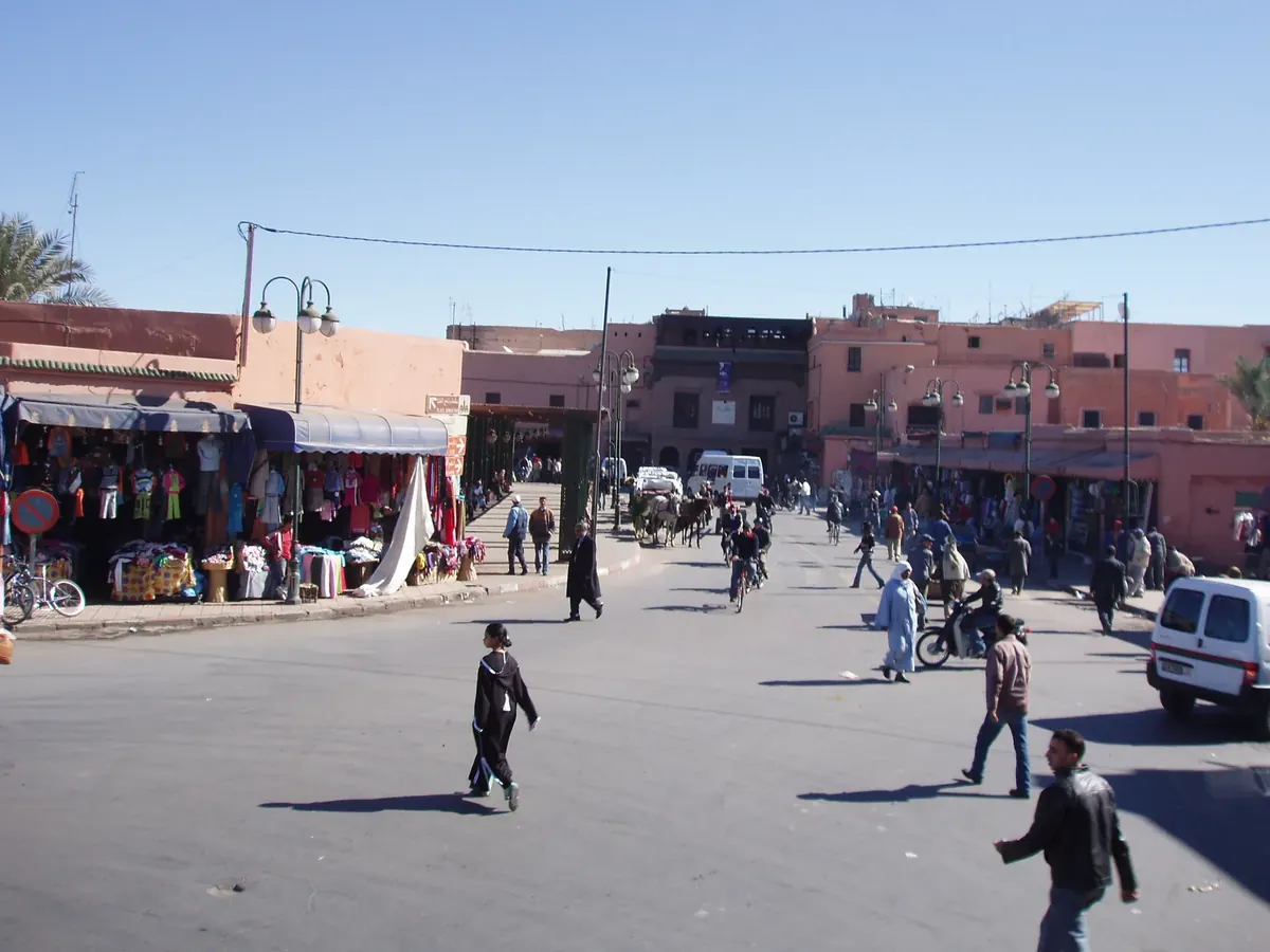 An archival view of shoppers and market stalls on a street in Marrakech’s historic Medina.