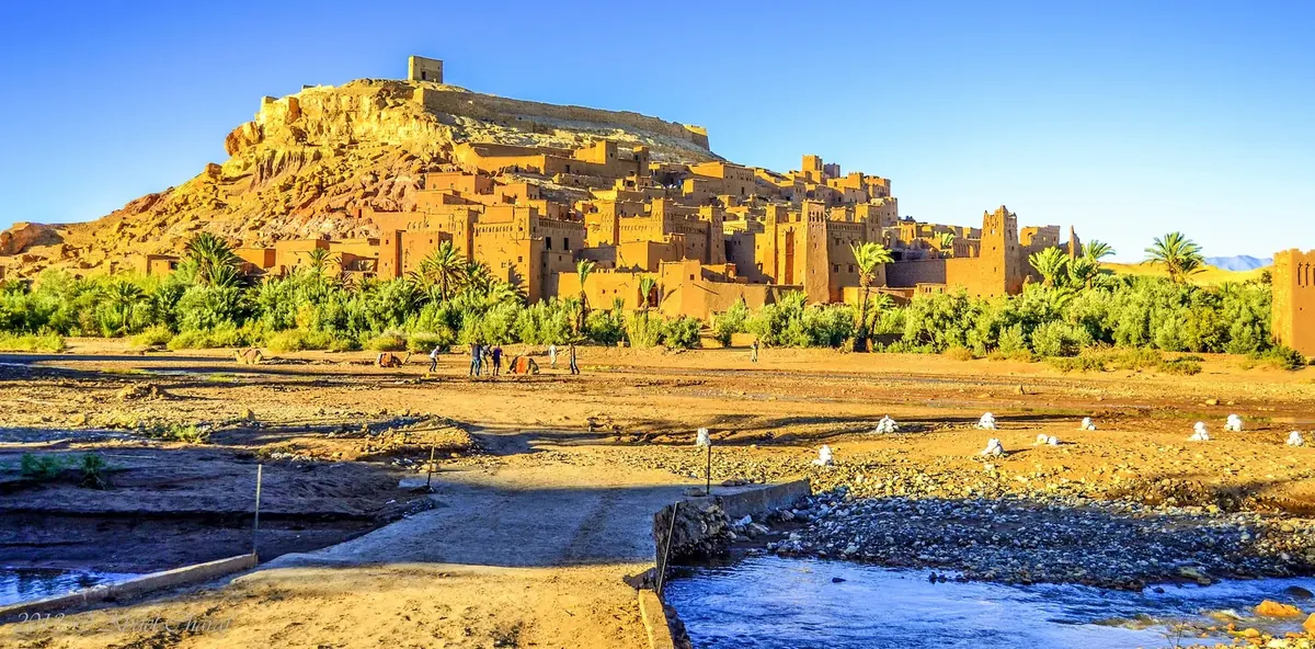 Earthen kasbah buildings of Aït Benhaddou in southern Morocco under a clear blue sky