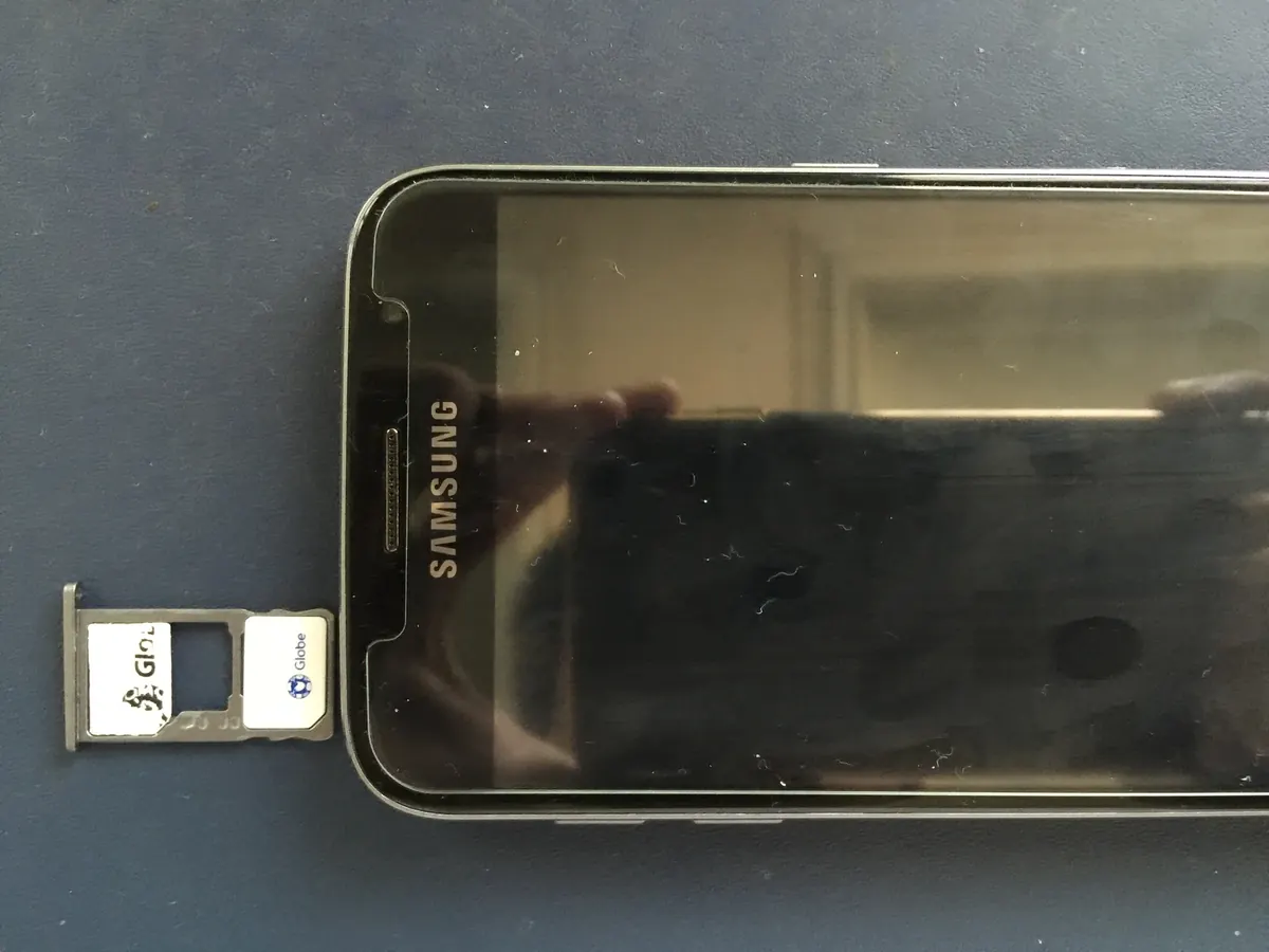 Original editorial illustration of an unbranded smartphone, physical SIM card and digital eSIM connectivity motif.