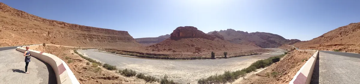 Panoramic view of a paved road running through Morocco’s desert landscape