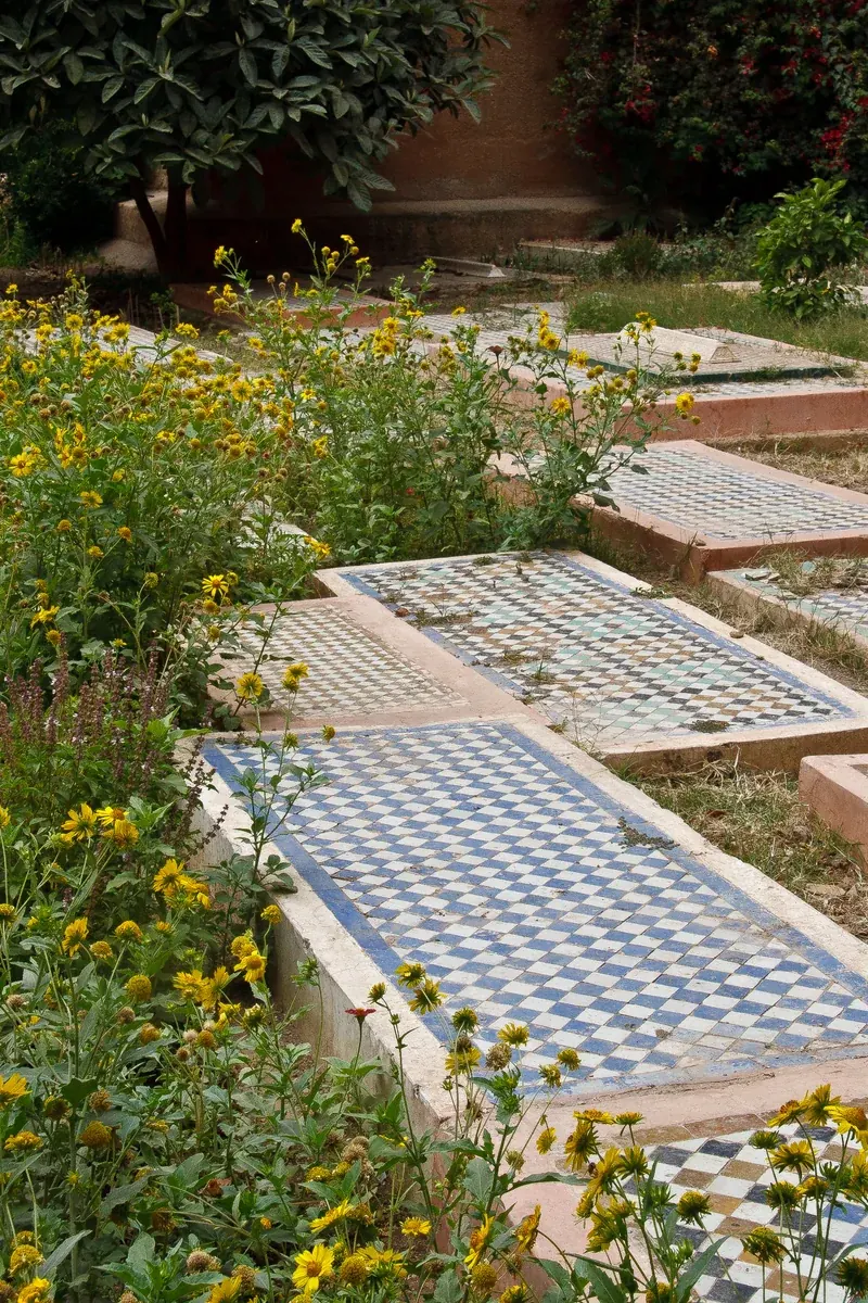 Garden courtyard and tiled graves at the Saadian Tombs in Marrakech