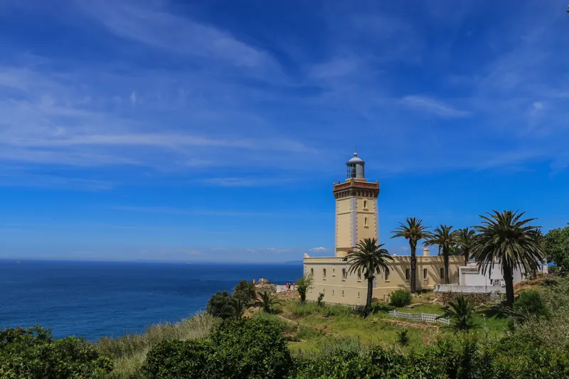 Cape Spartel lighthouse, palms and the Atlantic coast in Tangier, Morocco.