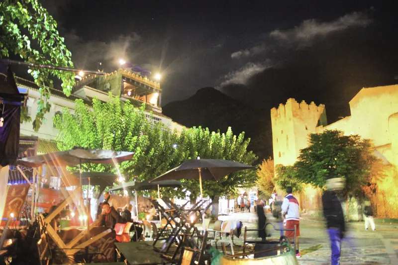 Café seating at night beside the Kasbah in Chefchaouen’s Place Outa el-Hammam