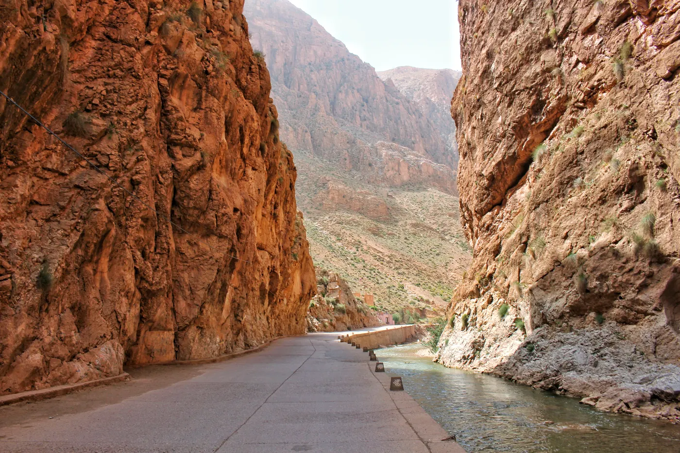A narrow road between red-brown rock walls in Dades Gorge, southern Morocco