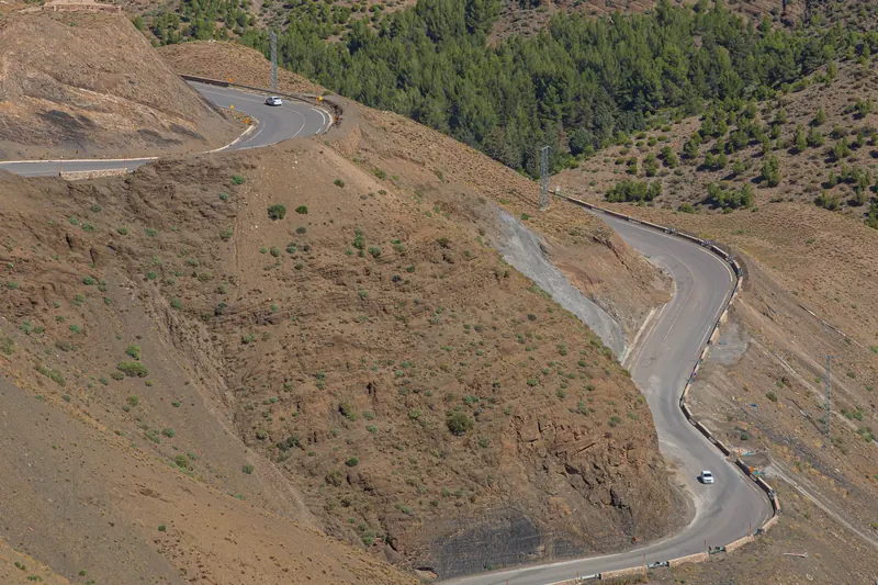 Cars negotiating two curving sections of the N9 at Tizi n'Tichka in Morocco's High Atlas