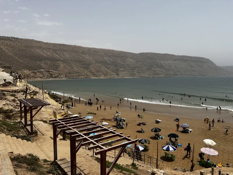 South Beach at Imsouane, showing the sandy shore, Atlantic water and surrounding cliffs.
