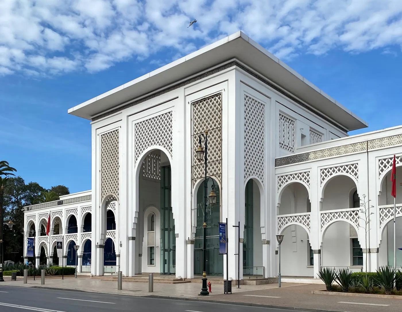 Side exterior of the Mohammed VI Museum of Modern and Contemporary Art in Rabat, with white arched façades and geometric screens