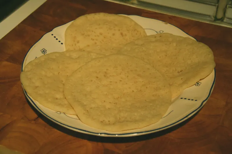 Homemade baghrir pancakes arranged on a white plate.