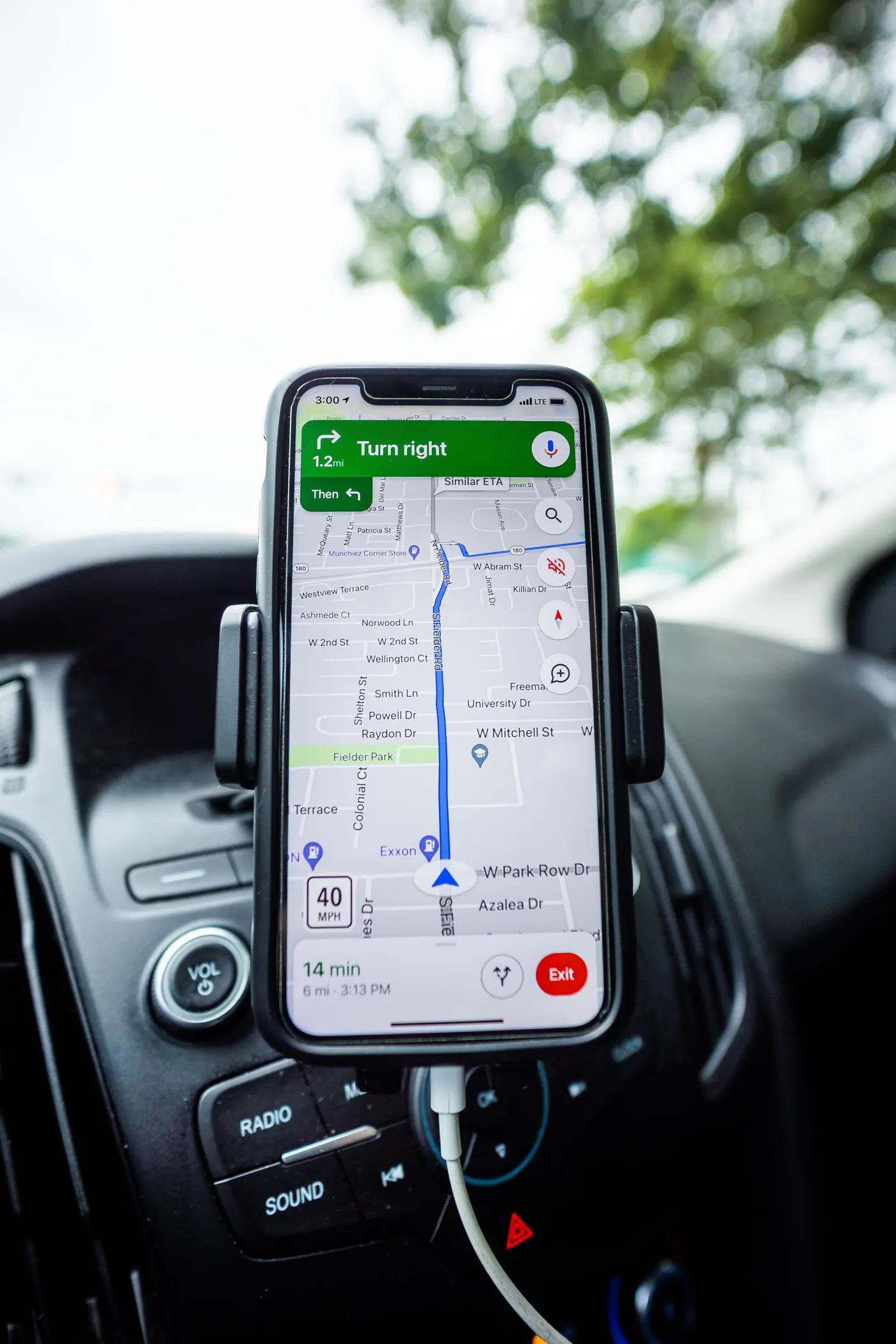 Smartphone displaying a navigation map on a car dashboard; generic stock photo, not Morocco.