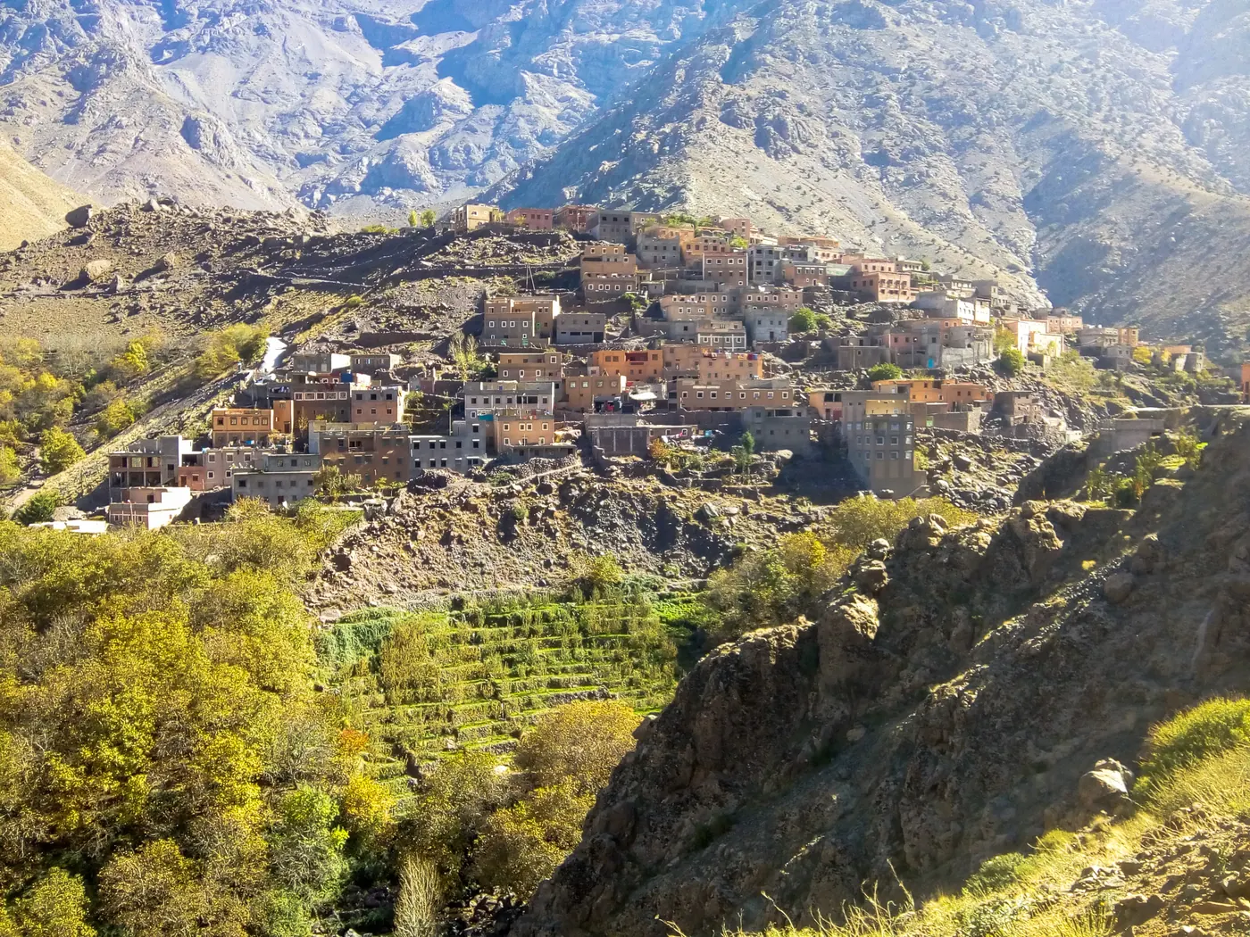 Hillside homes and cultivated terraces in Imlil beneath rocky High Atlas slopes