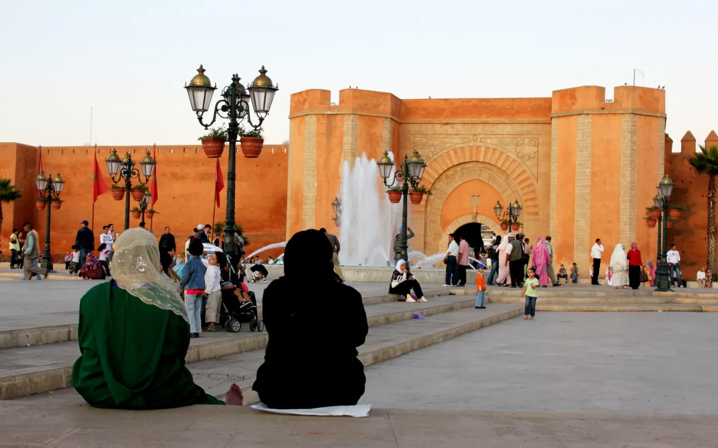 People sitting beside a fountain in front of the Bab El Had gateway in Rabat's Medina.