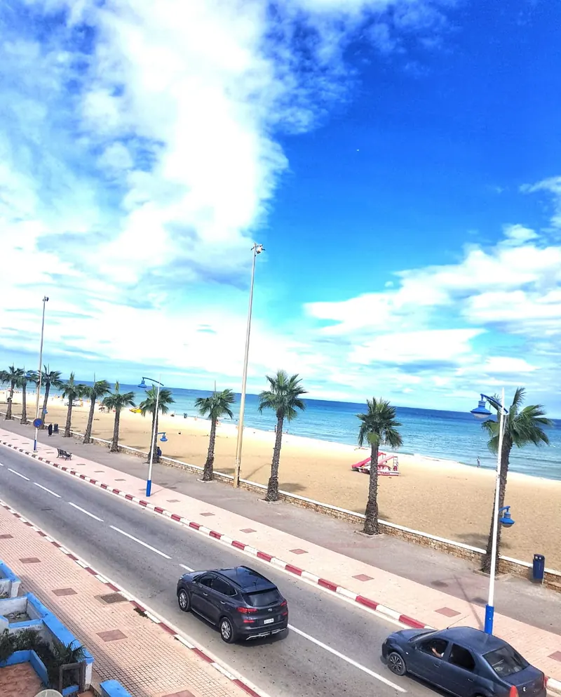 Martil beachfront with promenade, palms and Mediterranean water